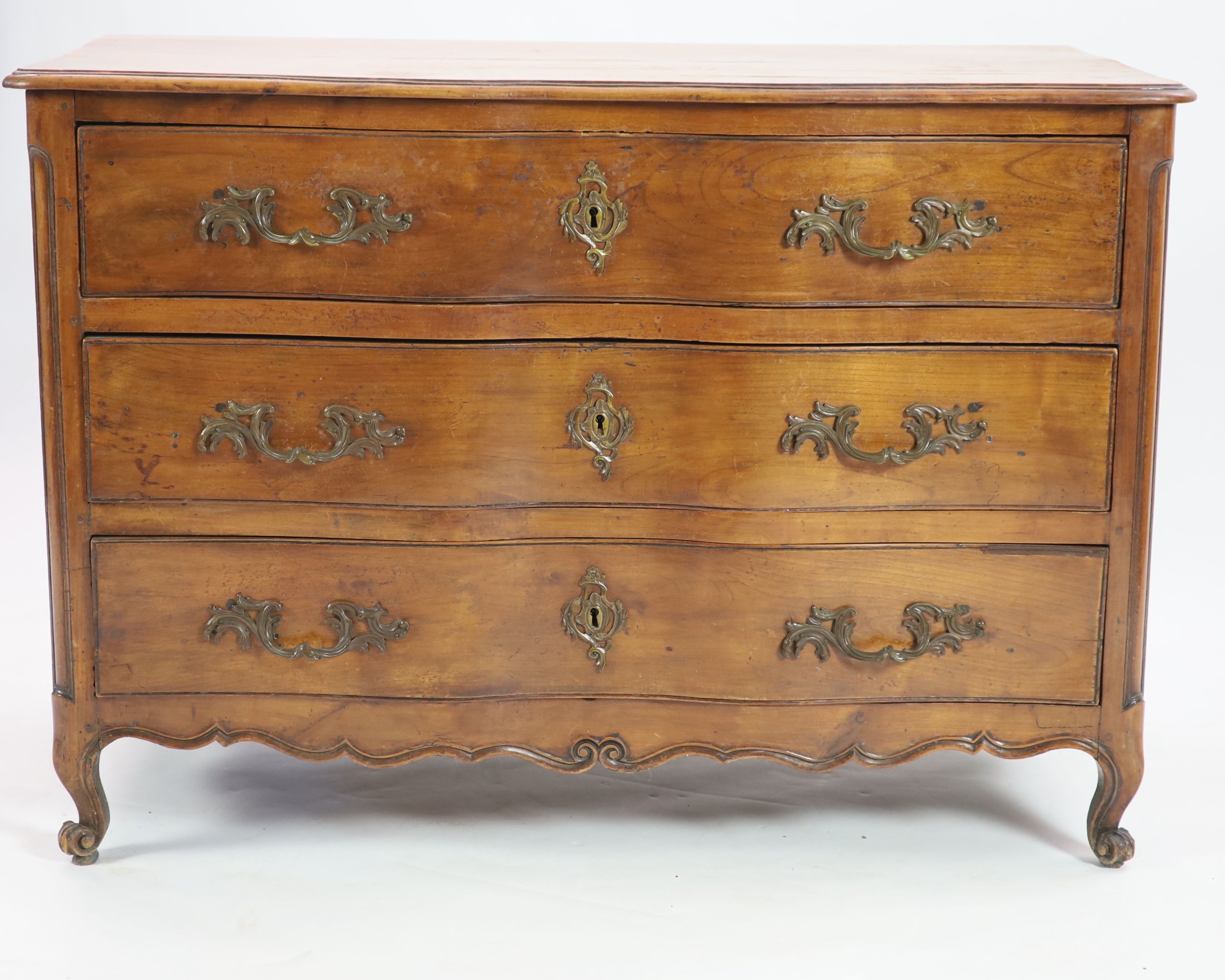 A Louis XV chestnut serpentine chest of three drawers, dated 1776, W.122cm D.63cm H.86cm
